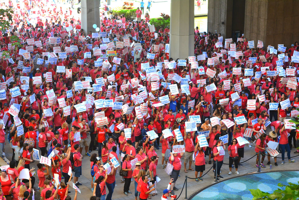 Teachers rally for more education funding.